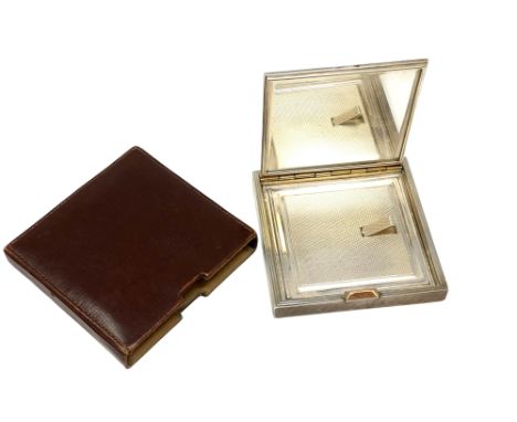 An Art Deco silver compact with engine turned decoration, David Sutton &amp; Sons, London, no date letter, in original leathe