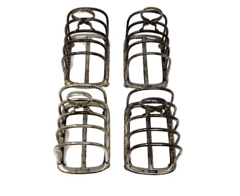 A near-set of four silver five-bar toast racks, William Hutton &amp; Sons Ltd, London 1904, 1905 and Sheffield 1904, each app