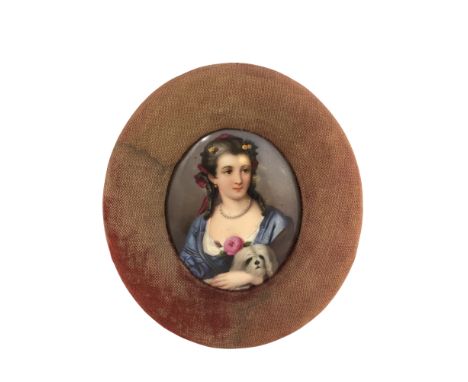 A fine early 19th century portrait miniature depicting a lady wearing a blue dress holding a small dog, 63 mm x 78 mm, framed