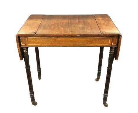 A Regency rosewood games table, inlaid with brass and with drop leaf extensions, the central sliding panel top with internal 