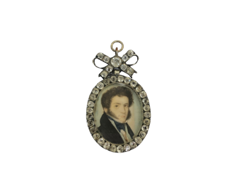 A Georgian portrait pendant miniature depicting a Gentleman with blue and white cravat with jacket, bordered in clear paste w