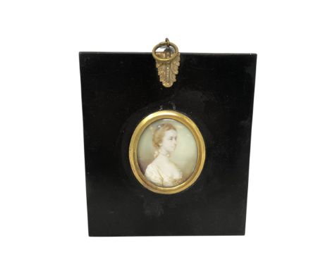 An early 19th century portrait miniature depicting a lady with blue ribbon in her hair, 4.5 cm x 3.5 cm, framed. CONDITION RE