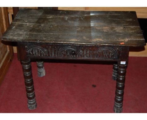 *An antique joined oak single drawer side table having line carving on bobbin turned supports, width 95cm