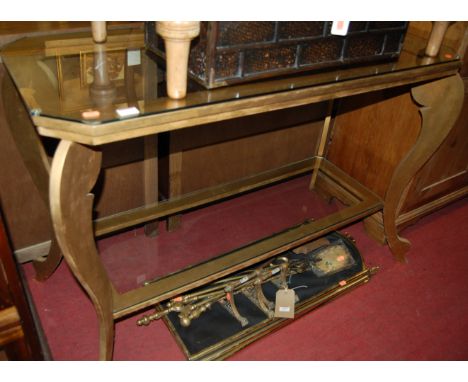 A contemporary gold spray painted and glass topped two tier console table, width 120cm