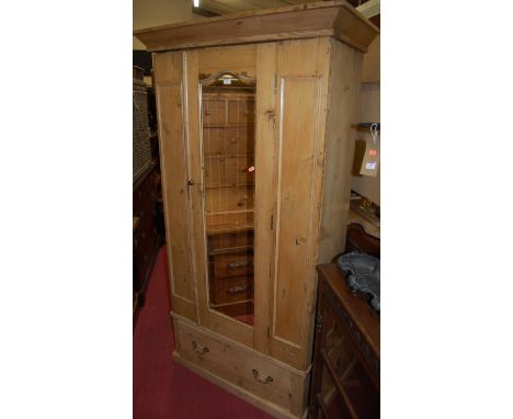 An Edwardian pine single mirror door wardrobe having single long lower drawer, width 102cm