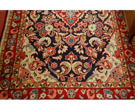 A Persian woollen blue ground rug, the floral ground within trailing tramline borders, 215x130cm   Condition Report / Extra I