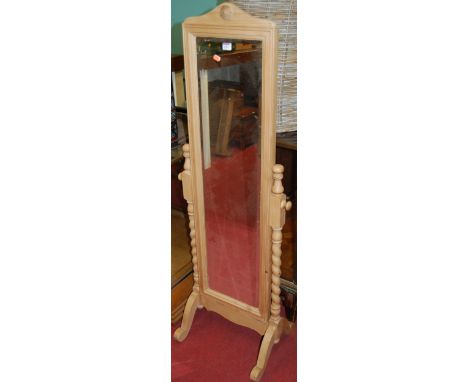 A modern pine cheval mirror raised on bobbin turned stand