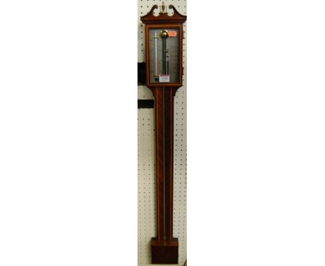 A reproduction mahogany stick barometer having a silvered dial