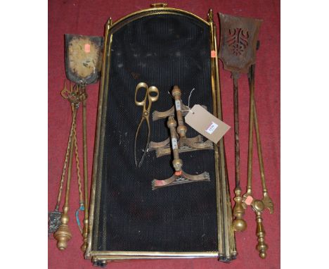 A collection of various late 19th century turned brass fire tools, together with a pair of fire dogs and a later folding spar