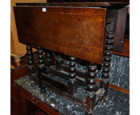 *An antique joined and bobbin turned oak dropflap gateleg occasional table 