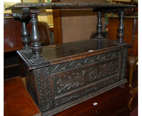 A circa 1900 low relief carved oak fold over monks bench having typical hinged box seat base, width 87cm