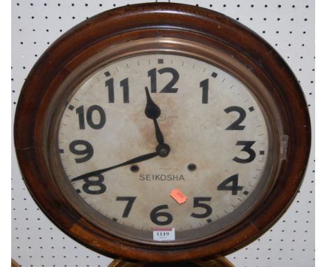 An early 20th century oak circular wall clock, the dial signed Seikosha