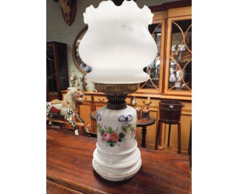 Floral decorated porcelain oil lamp with glass bowl shade 
