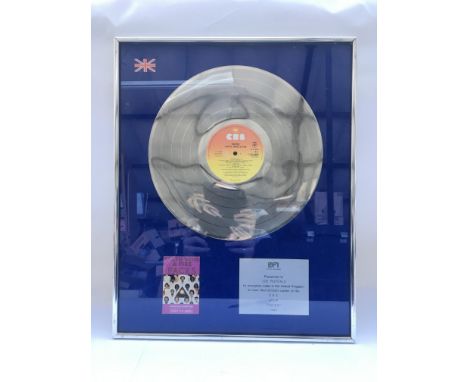 A framed and glazed Earth Wind And Fire presentation 'silver' disc for the Album 'Faces', B.P.I certified. Presented to Joe R