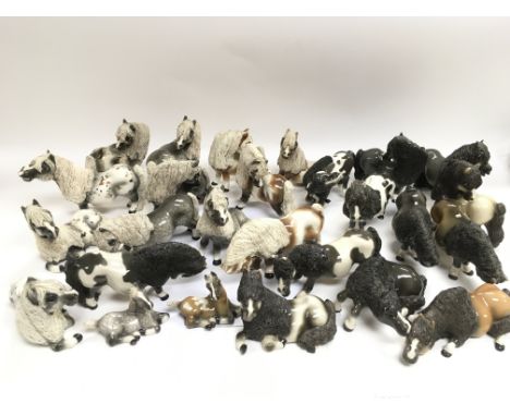 A collection of over 25 Cheval ceramic horses.