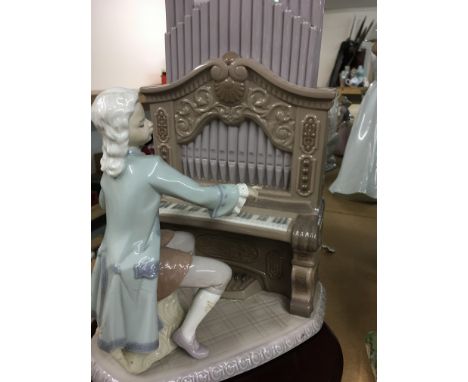 A Lladro figure of a organ player .28 cm .