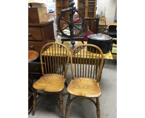 A small Early 20th century pine kitchen table an old spinning wheel an enamel cooking pot and two elm and beech chairs (a lot