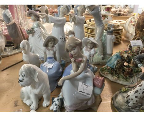 A collection of figures including Lladro Nao , and others.