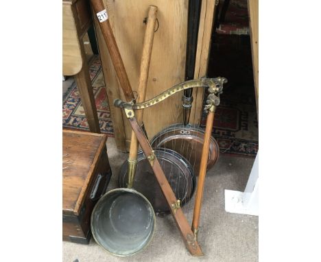 An unusual brass and metal harp coat rack a brass cooking pot with e tended handle and two 19th century bed pans (4)