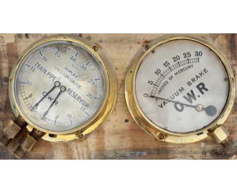 A pair of GWR brass cased locomotive gauges mounted on a board. One is a loco vacuum Brake gauge, 6.25in diameter, the other 