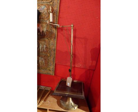 A French designer brass lamp on adjustable supports 