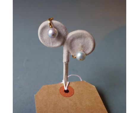 A pair of 9ct gold and pearl clip-on earrings on a stand together with a spinach jade pendant having a gold mount