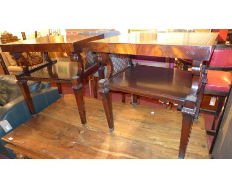 A pair of Regency style mahogany lamp tables with leather lined tops and brass grille detail to the ends