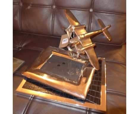 An Art Deco style model of an aeroplane in flight together with two silver plated photograph frames