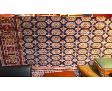 A Bokhara style carpet with blue field and gul motifs in a multi border
