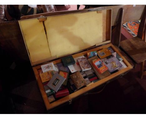 A large and interesting collection of various playing cards in an oak trunk 