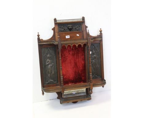 Late 19th century Aesthetic Movement Walnut Hanging Wall Shelf with pierced brass gallery rails and relief metal panels depic