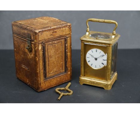A gilt-brass repeater carriage clock, the white enamel dial with Roman numerals denoting hours, with movement striking hours 