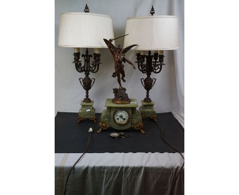 A french garniture to consist of green onyx clock decorated with Hermes together with two four branch lamps on green onyx bas