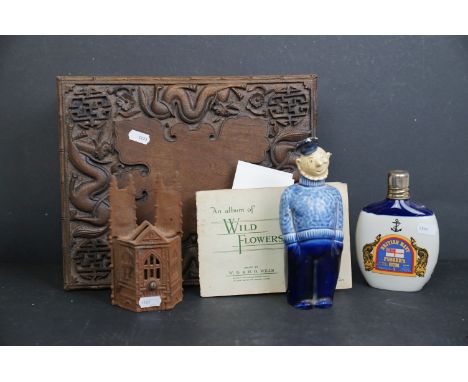 A box of mixed collectables to include a wooden folding stool, a Pussers rum bottle, vintage wrought iron money bank in the f