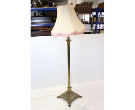 Brass Corinthian Column Standard Lamp raised on a stepped square base with lion paw feet, with shade, 147cms high 