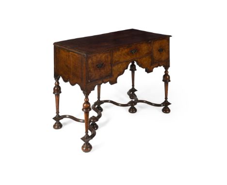 QUEEN ANNE WALNUT LOWBOY EARLY 18TH CENTURY the quarter veneered top above three drawers arranged around and arch, raised on 