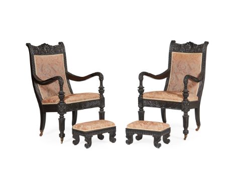 PAIR OF ANGLO-INDIAN EBONY ARMCHAIRS AND ASSOCIATED FOOTSTOOLS MID 19TH CENTURY the frames carved with shell, leaf, and flowe