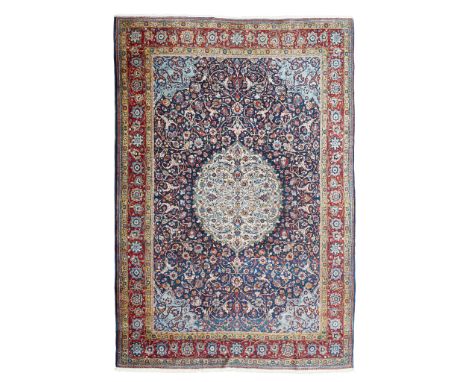 TABRIZ CARPET NORTHWEST PERSIA, EARLY 20TH CENTURY the indigo field with camel medallion, light blue spandrels, within dark r