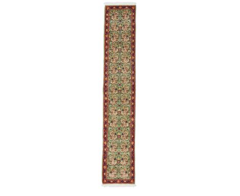 SAROUK RUNNER WEST PERSIA, MODERN the light green field with allover floral spray pattern, within red floral vine border(383c