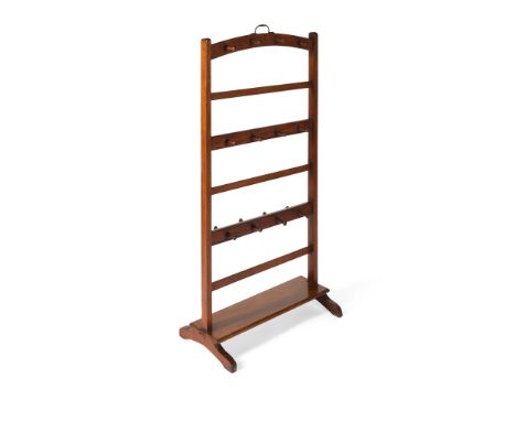 LATE REGENCY MAHOGANY HAT, BOOT, AND WHIP STAND EARLY 19TH CENTURY with three tiers of wood pegs on a trestle base(56.5cm wid
