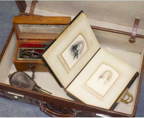 AN EARLY 20TH CENTURY LEATHER TRAVELLING CASE 61cm wide together with a late 19th / early 20th century embossed leather photo