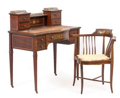 AN EDWARDIAN MAHOGANY AND SATINWOOD INLAID LADIES DESK with a gilt galleried top, nine drawers, square tapering legs and bras