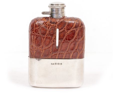 A FAUX CROCODILE SKIN LEATHER MOUNTED SILVER FLASK with marks for Birmingham 1934, 10cm x 15cm