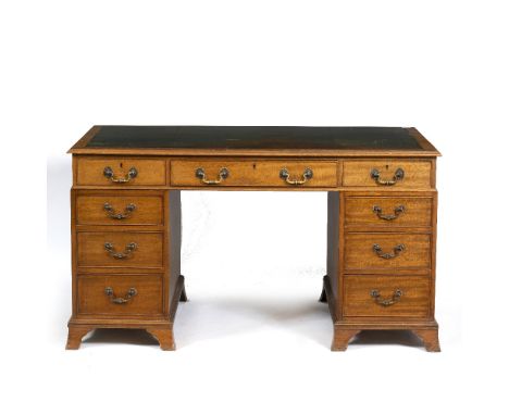 A VICTORIAN MAHOGANY PEDESTAL DESK with a green gilt tooled leather inset top above a fitted long drawer, flanked by six shor
