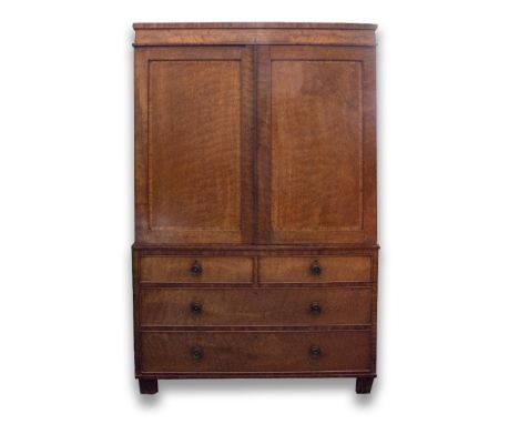 AN EARLY VICTORIAN MAHOGANY LINEN PRESS with twin panel doors opening to reveal three sliding trays above two short and two l