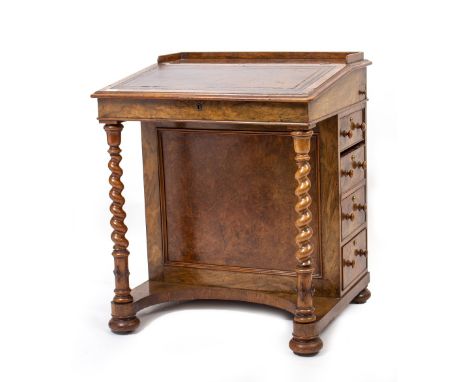A 19TH CENTURY WALNUT DAVENPORT with galleried and leather inset top and a maple interior, fitted with three drawers and thre