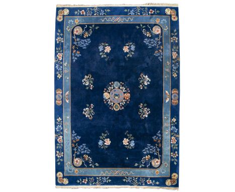 A LARGE 20TH CENTURY CHINESE BLUE WOVEN SILK CARPET decorated with flowers and scrolling leaves, with fringed edges, 368cm x 