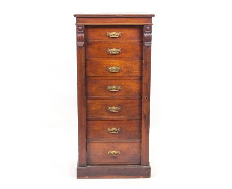 AN ANTIQUE MAPLE &amp; CO MAHOGANY WELLINGTON CHEST with a set of six graduated drawers, with brass handles, standing on a pl