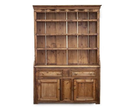 A 20TH CENTURY PINE DRESSER  with pierced cornice over  four shelves, two frieze drawers and two panelled doors 137cm x 48cm 