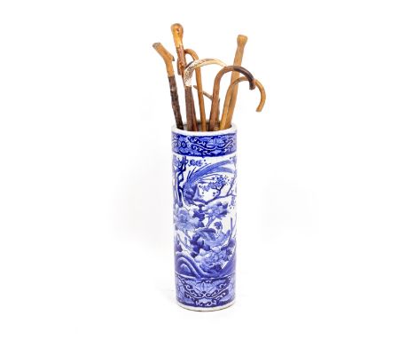 A BLUE AND WHITE CHINESE CYLINDRICAL STICK STAND 64cm high overall, decorated with fanciful bird amongst trees and foliage, a